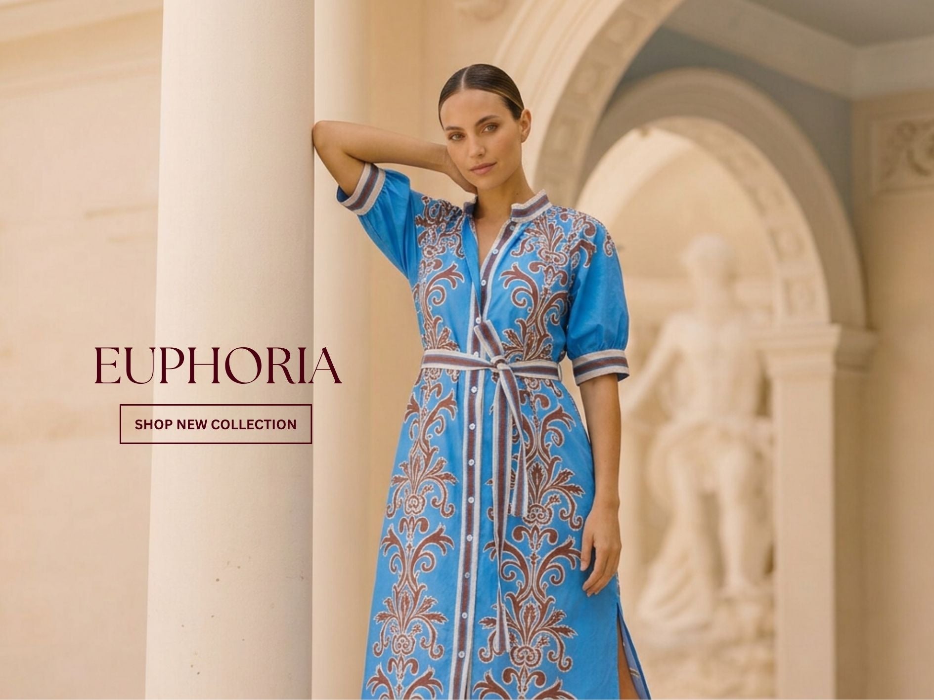 A woman models a blue embroidered kaftan dress with brown and white patterns in an elegant indoor setting with arches. The brand name 'EUPHORIA' is displayed on the left side of the image.